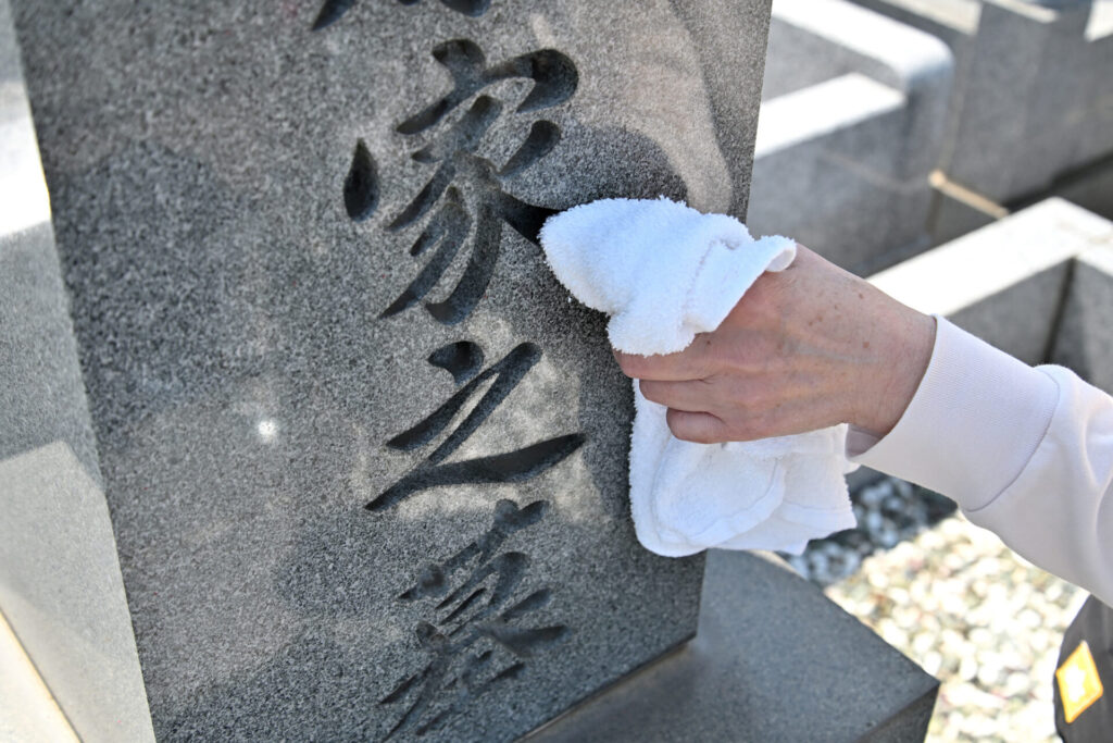 先祖の墓を掃除している写真